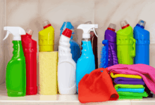a variety of cleaning supplies including a spray bottle and microfiber cloths on a clean countertop create in horizontal format do not write text on image