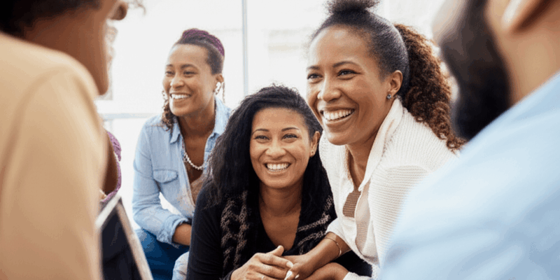 diverse people connecting and smiling during a deep conversation at a social gathering horizontal format no text