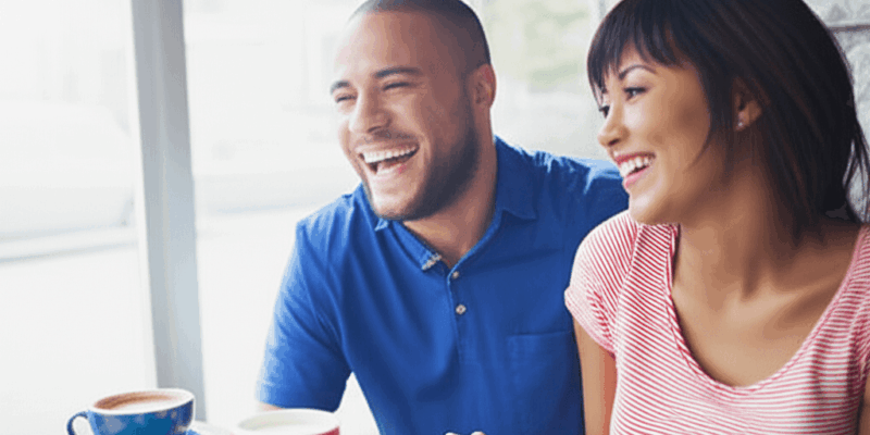 a couple laughing and connecting during a coffee date horizontally