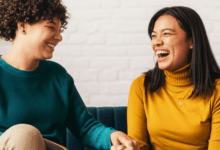 two friends laughing during a meaningful discussion horizontally