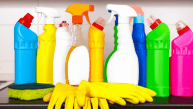 a variety of cleaning products and tools arranged neatly on a countertop ready for use create in horizontal format do not write text on image
