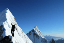 a person climbing a mountain symbolizing overcoming challenges horizontal format no text