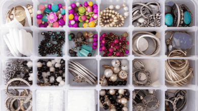 various imitation jewelry pieces neatly organized in a transparent storage box with silica gel packets create in horizontal format do not write text on image