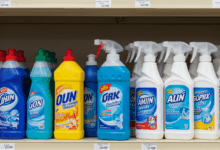 a variety of cleaning supplies and detergents neatly arranged on a shelf ready for stain removal create in horizontal format do not write text on image