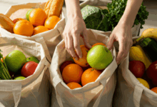 hands sorting groceries into reusable bags with a focus on cost saving create in horizontal format do not write text on image
