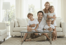 a family smiling in a clean and bright living room create in horizontal format do not write text on image