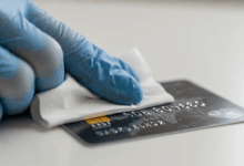credit card being disinfected with an alcohol wipe create in horizontal format do not write text on image