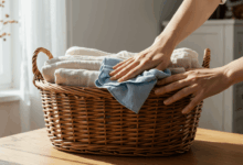hands gently cleaning a wicker basket with a damp cloth in a bright room create in horizontal format do not write text on image