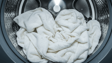 close up of a washing machine drum filled with white towels on a hot wash cycle create in horizontal format do not write text on image