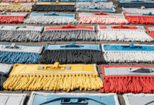 a variety of clean mop heads drying in the sun create in horizontal format do not write text on image