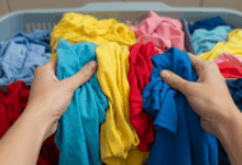 hands carefully sorting different colored garments before washing create in horizontal format do not write text on image