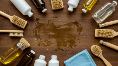 top down shot of various cleaning products like oils solvents and brushes arranged neatly around a stubborn wax stain on a wooden table with a microfiber cloth ready for use natural and bright studio lighting
