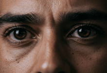 A man's eyes conveying unspoken emotions a mix of sadness and determination