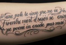 close up of artistic script tattoo in French