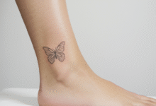 minimalist line art butterfly tattoo on an ankle with a clean aesthetic