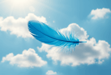 A vibrant blue feather floating gracefully in a clear blue sky surrounded by gentle clouds