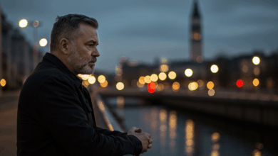 A man standing alone on a bridge looking reflective with a blurry city background representing introspection and personal struggles leading to disinterest in a romantic relationship