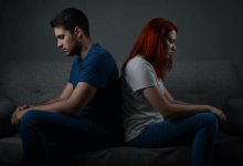 a couple sitting back to back symbolizing communication problems